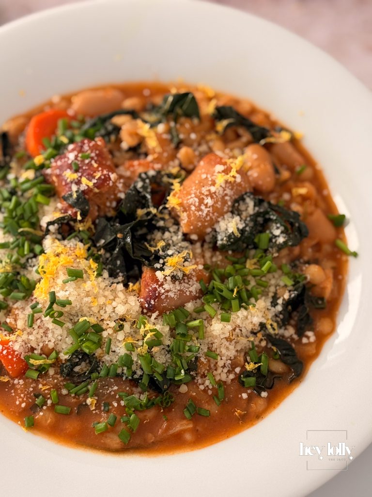 Close-up of pearl barley stew showing plump grains of barley, tender carrots and pieces of sausage
