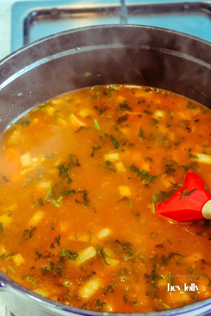 Pearl barley stew fresh from the oven with golden sausages nestled into barley and carrots