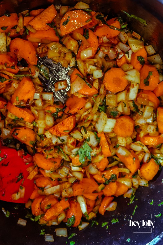 Chunky carrot batons and pearl barley stirred into the pot before stock is added for the stew