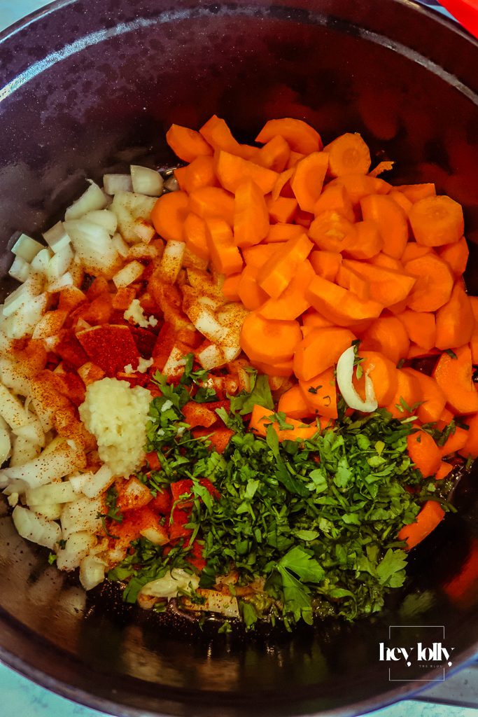 Chunky carrot batons and pearl barley stirred into the pot before stock is added for the stew