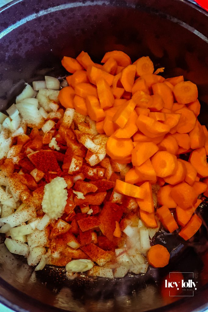 Onions and garlic sautéing in olive oil in a pot, forming the flavour base for pearl barley stew