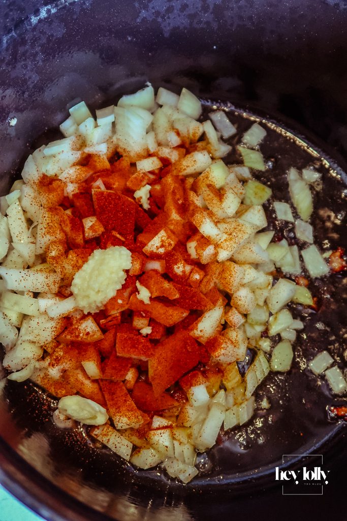 Onions and garlic sautéing in olive oil in a pot, forming the flavour base for pearl barley stew