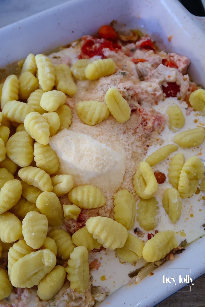 Gnocchi stirred into the creamy sauce for salmon and fennel gnocchi bake before the final bake
Parmesan topping:
