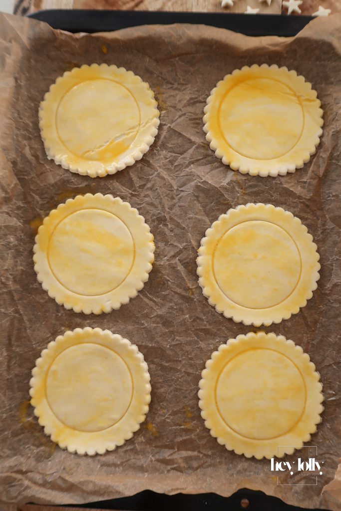 Cutting puff pastry into rounds for individual plum and vanilla custard tarts