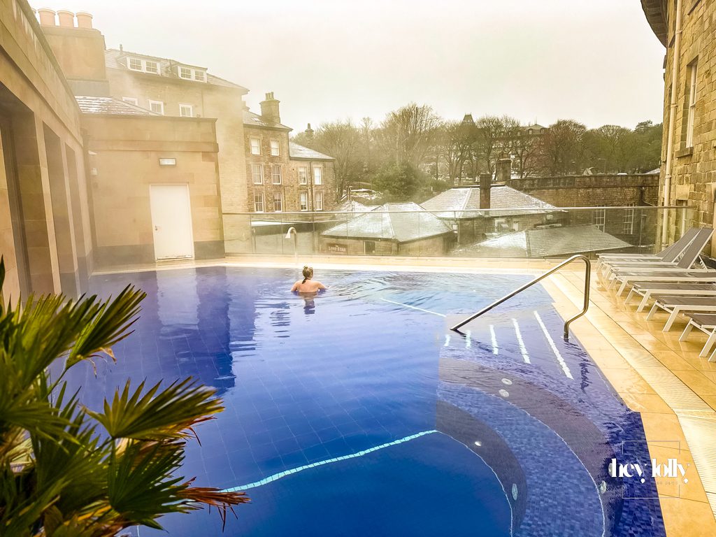 Warm rooftop pool with historic rooftops and Peak District air