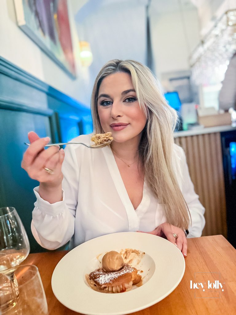 Woman enjoying Paris-Brest dessert during dinner at Skein Nottingham