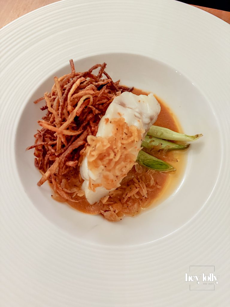 Butter poached cod with pil pil, leeks and matchstick fries at Skein Nottingham
