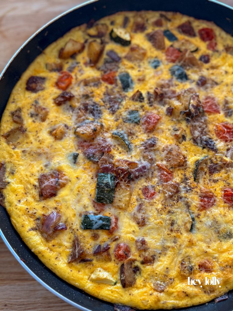 overhead fridge raid frittata with cherry tomatoes herbs and shaved parmesan