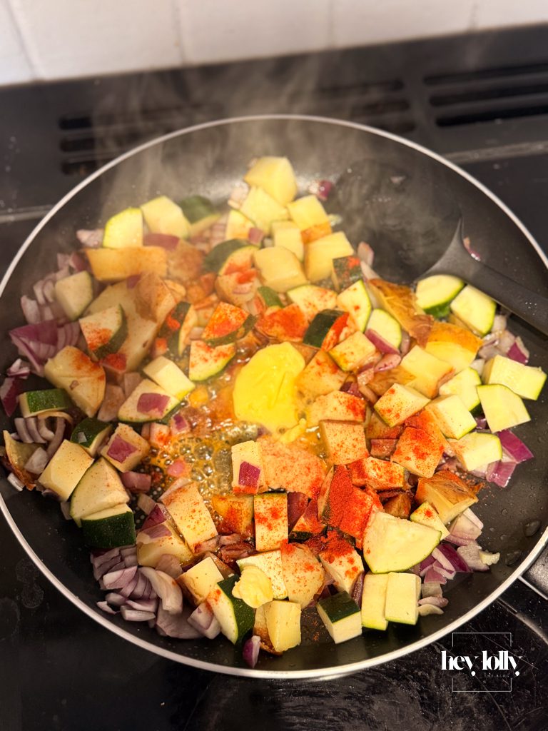 vegetables sautéing in pan for fridge raid frittata with paprika and butter