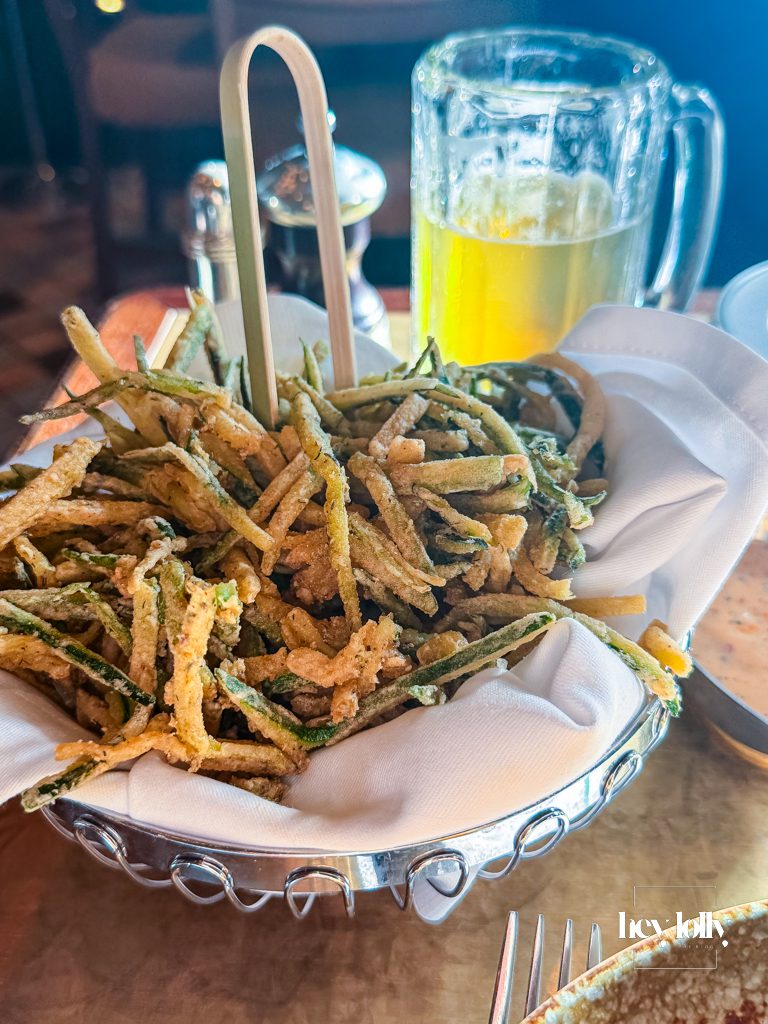 Crispy courgette fries served in a silver basket with dipping sauce at The Ivy Nottingham