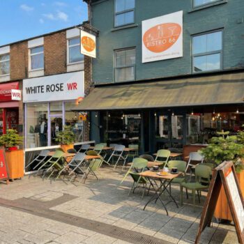 Exterior of Bistro 66 on High Road in Beeston with large front windows and outdoor seating