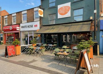 Exterior of Bistro 66 on High Road in Beeston with large front windows and outdoor seating