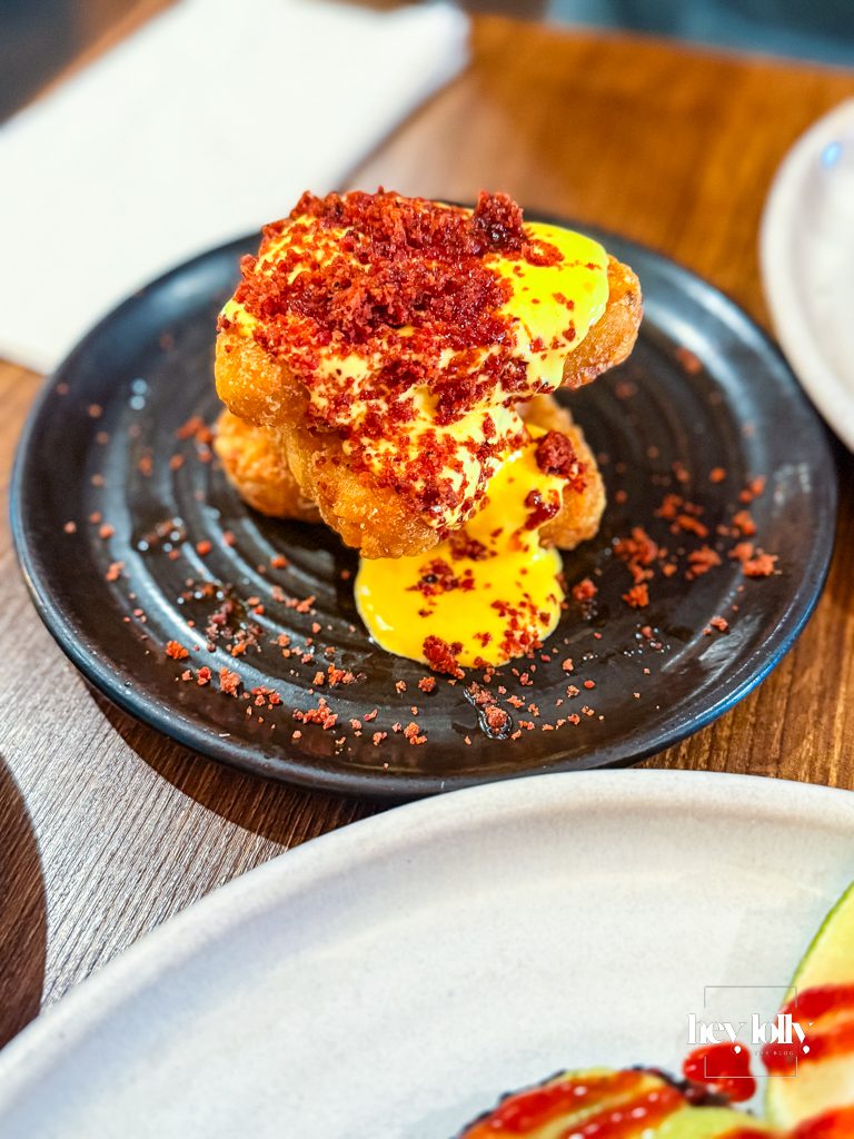 Crisp chorizo hash browns topped with rich yellow sauce at Bistro 66 in Beeston