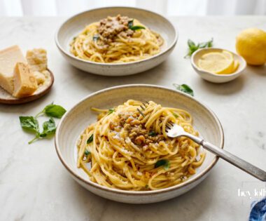 Preserved lemon pasta with roasted walnut pesto, basil and grated parmesan in a ceramic bowl